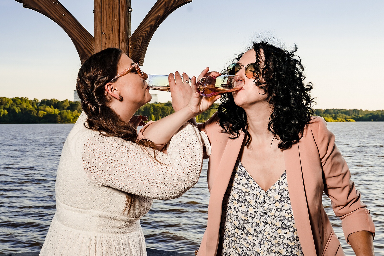 Two brides share champagne after their intimate same-sex elopement