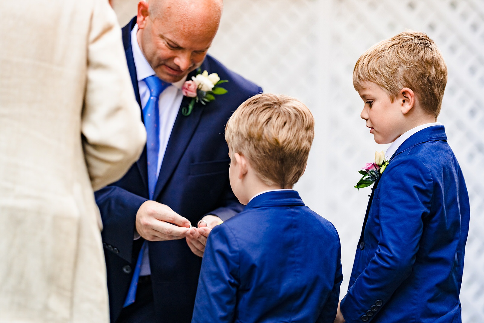 Groom shows his sons the wedding rings