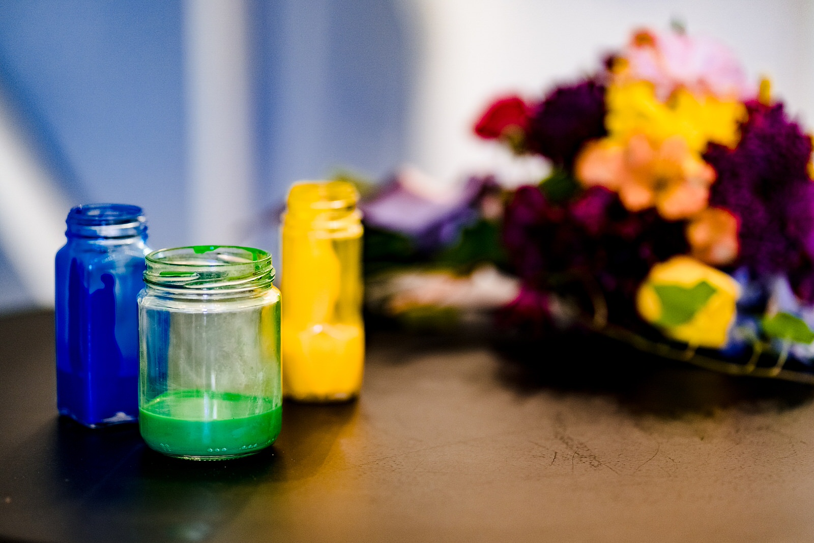 Paint jars await a custom paint pour unity ceremony at this colorful wedding inspiration styled shoot