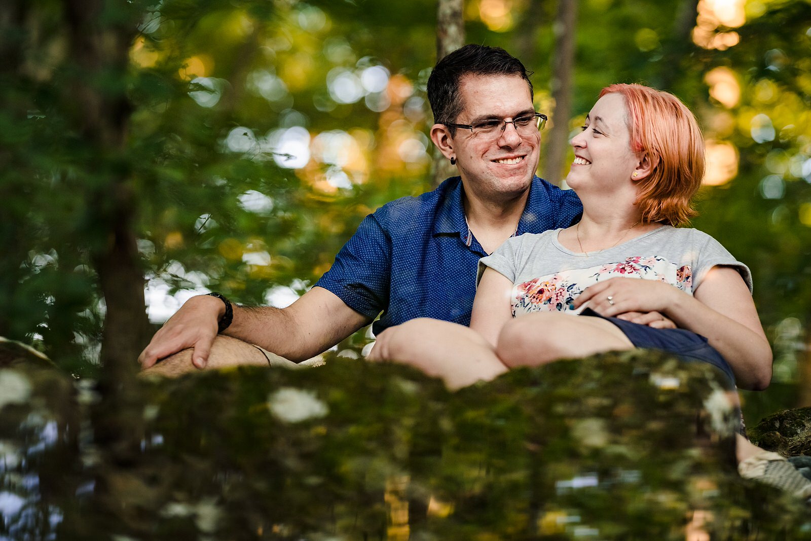 An engaged couple laughs together during their Durham engagement photos