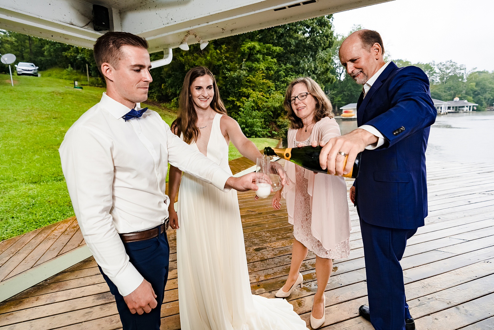 parents of the bride pour champagne for the newlyweds