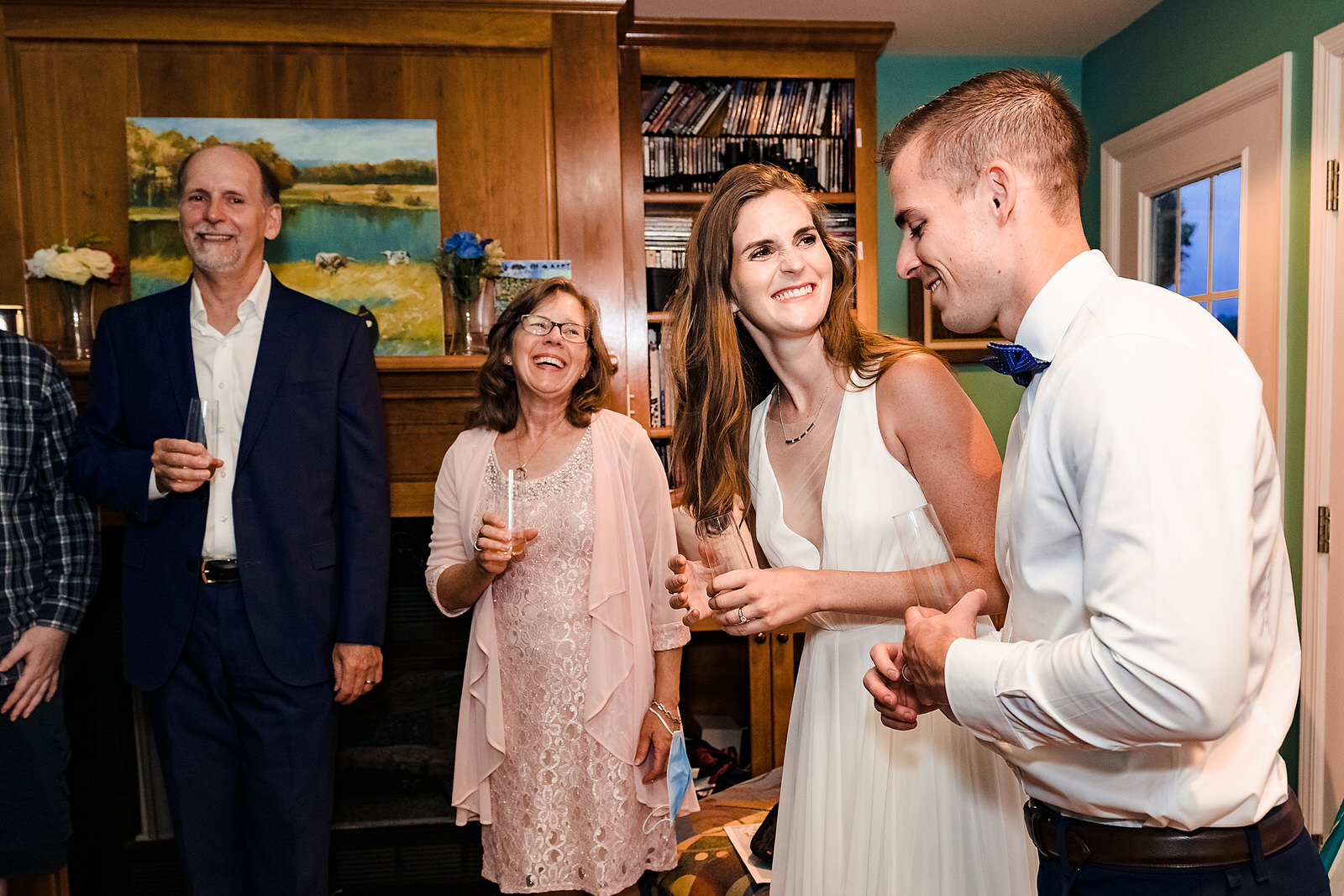 bride and groom laugh during toasts at this intimate AirBNB wedding