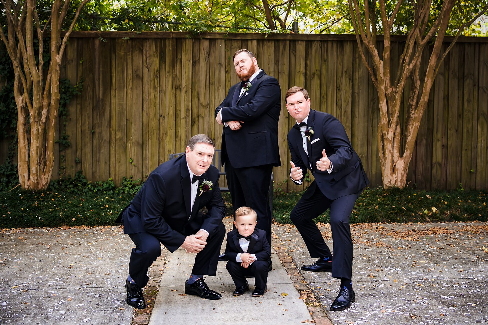 Groom and his family, including the ring bearer, strike funny poses