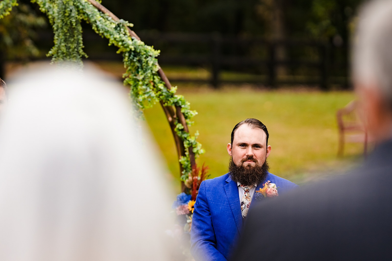 Groom watches as bride heads up the aisle with her stepfather