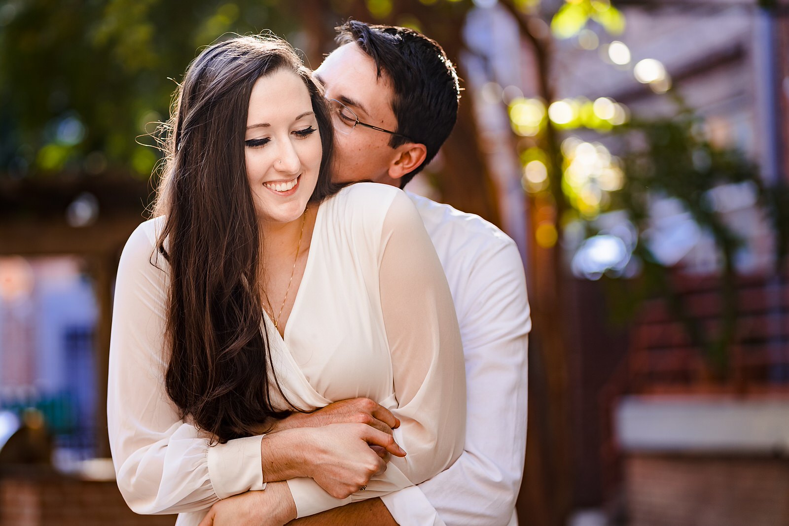 Groom hugs on bride at a casual elopement