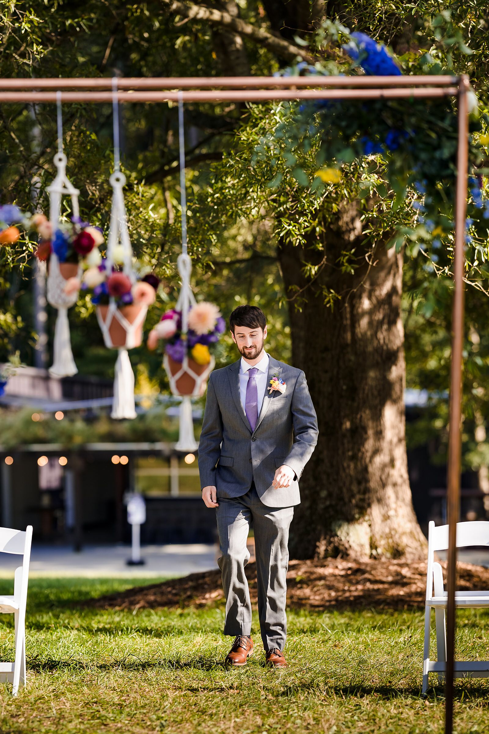 Groom walks in to his intimate wedding ceremony at the Meadows Raleigh