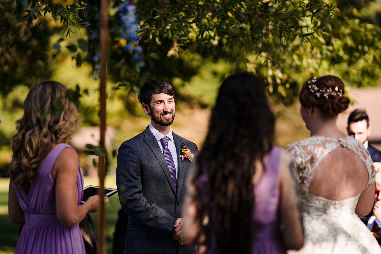 Groom looks lovingly at bride during wedding ceremony