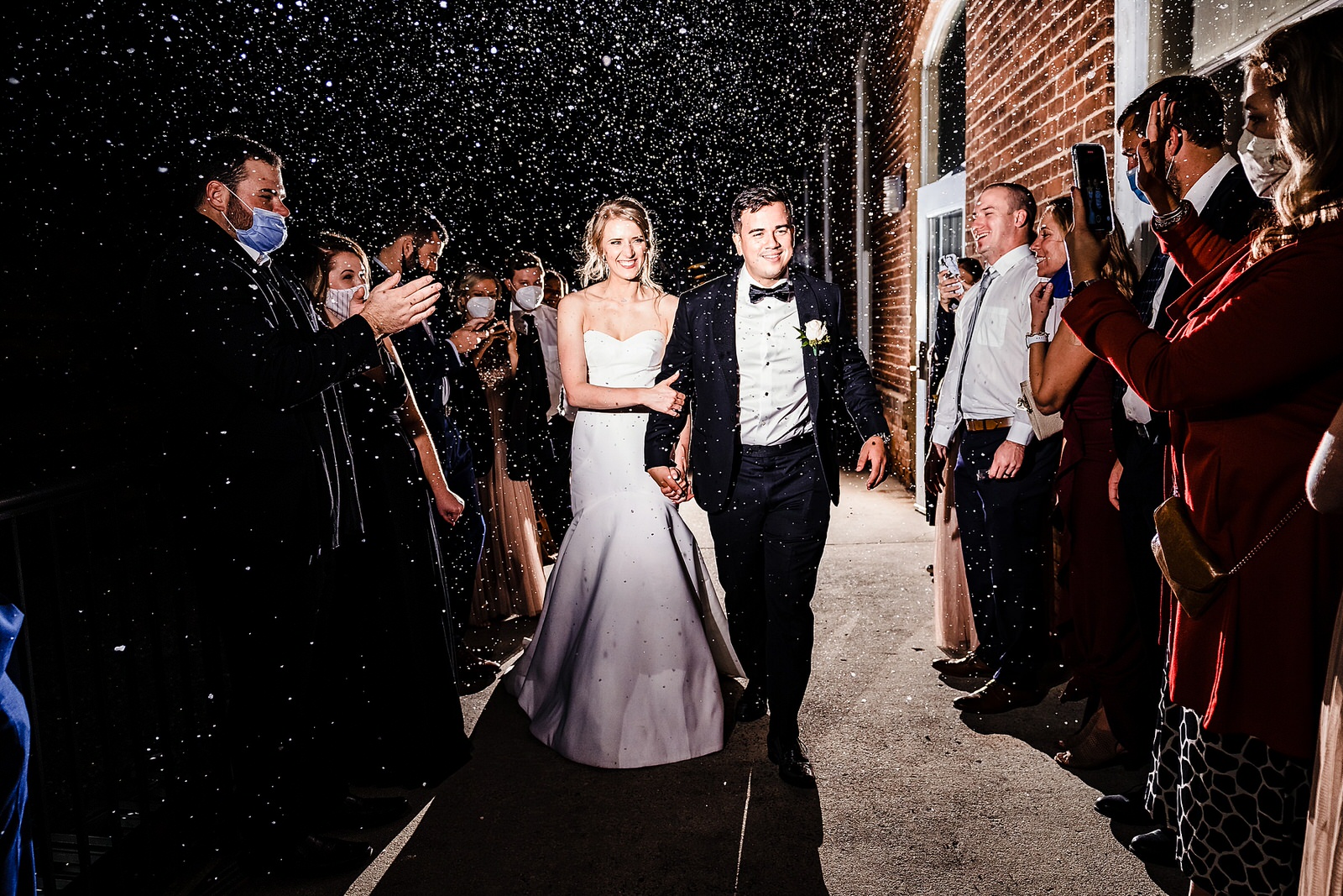 Snow machine exit at a Christmas wedding in Durham, NC
