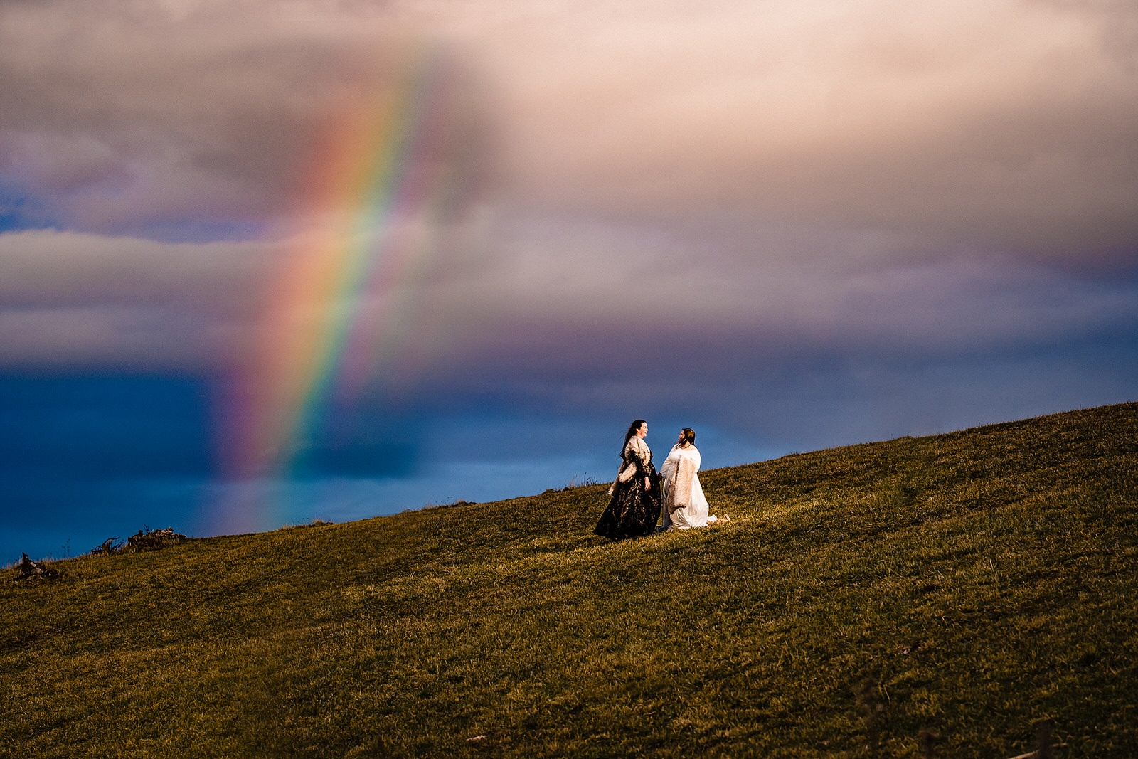 Same-sex wedding portraits with a rainbow