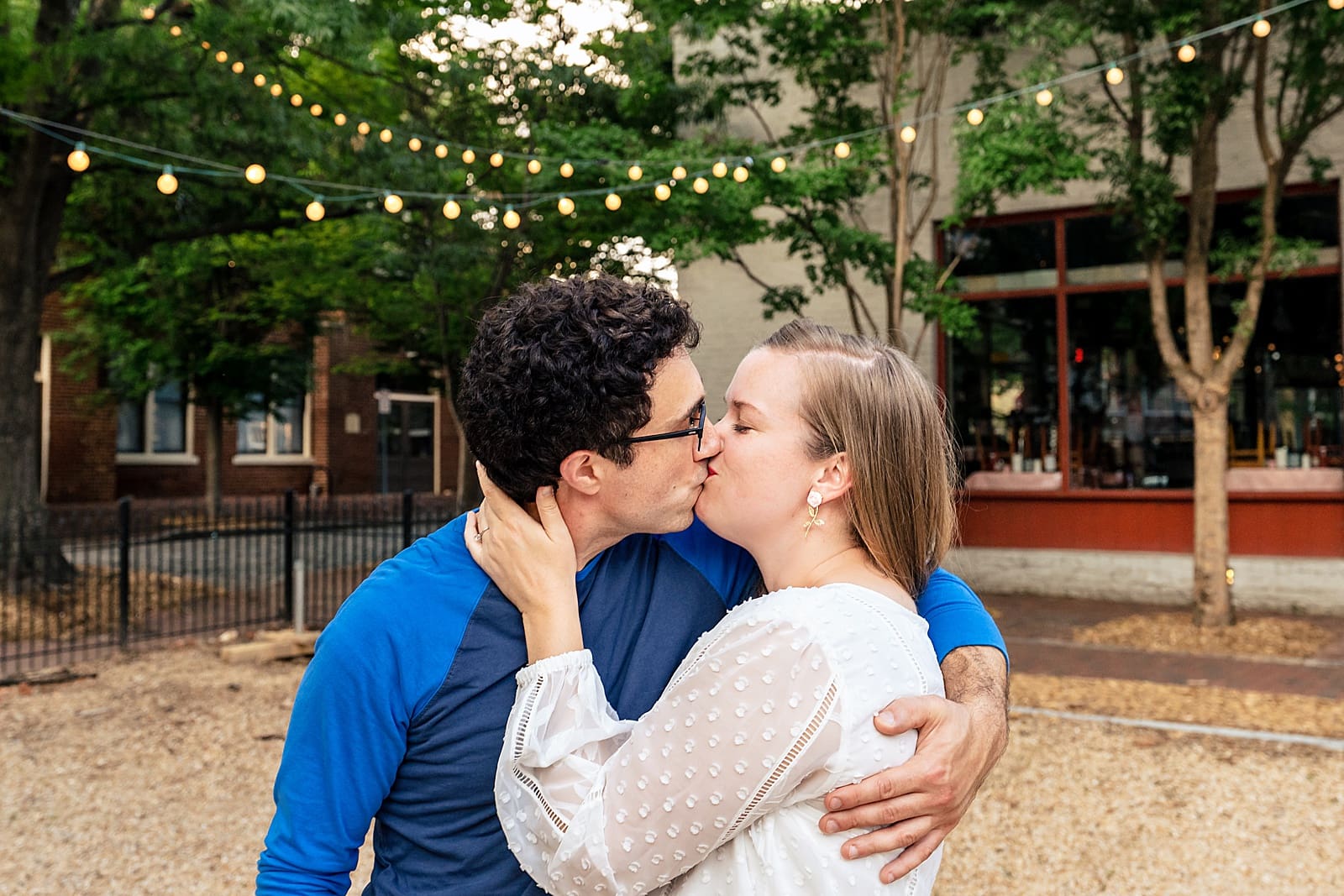 City Market Engagement Photos - couple laughs and walks through City Market in downtown Raleigh