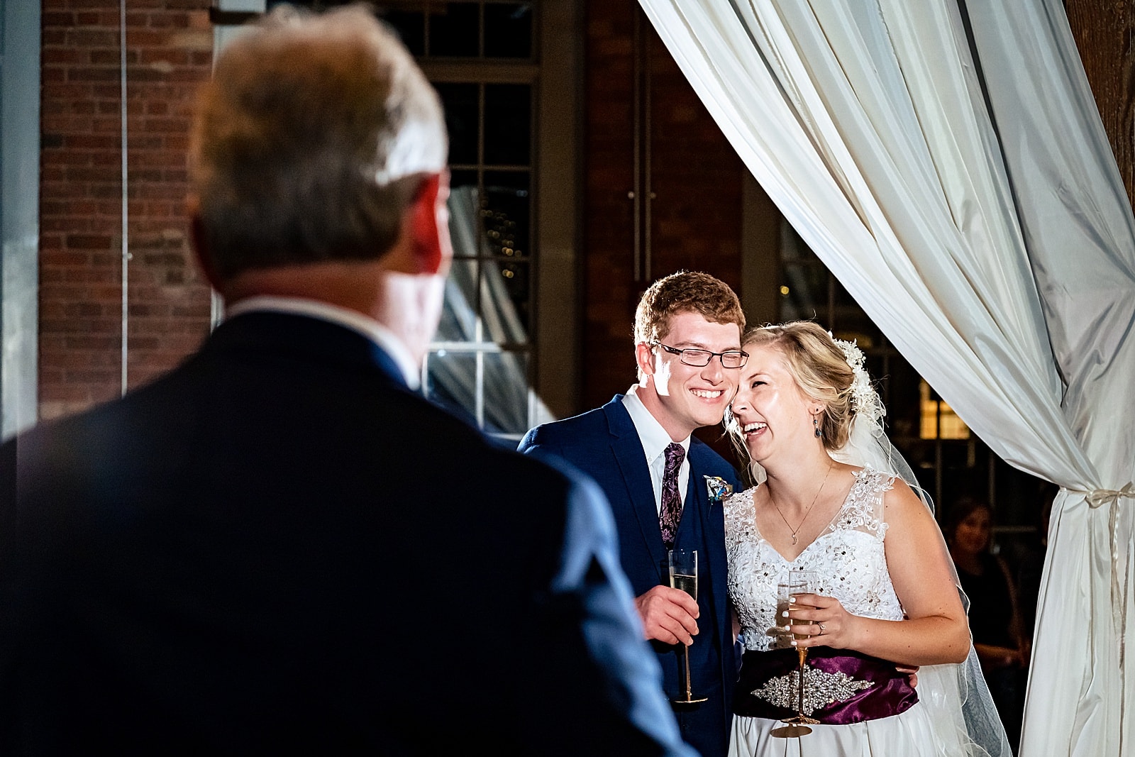 Couple reacts to the toast from the father of the bride