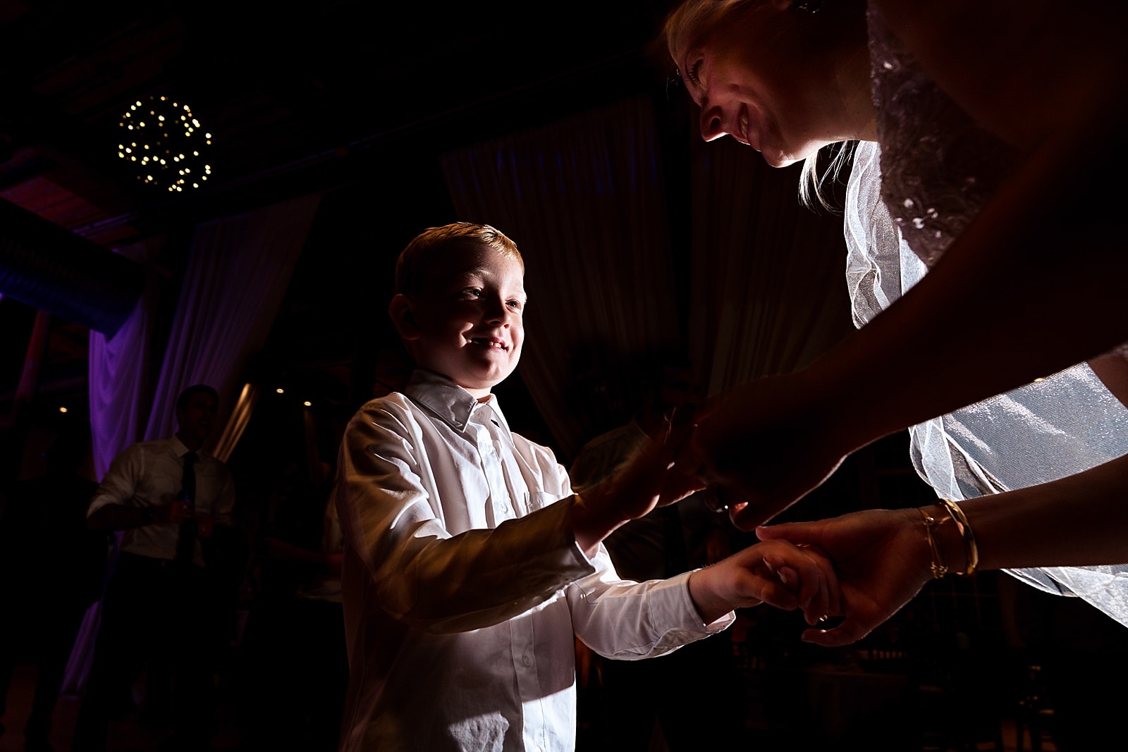 bride dances with the ring bearer at a super fun wedding