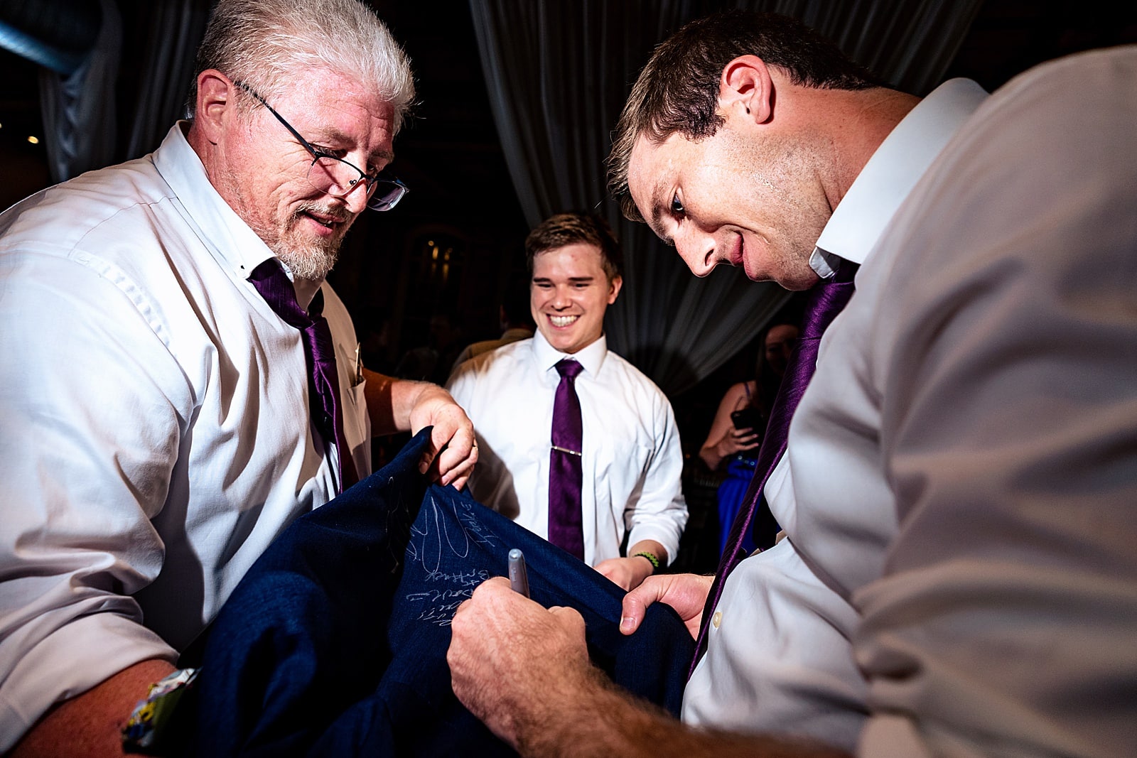 This groom's groomsmen signed his suit jacket as part of a group tradition