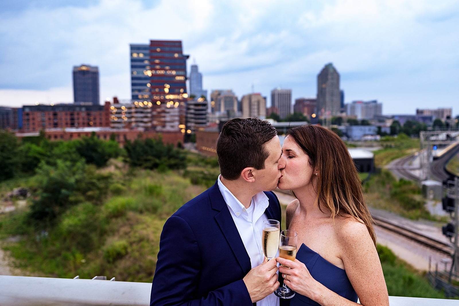 Raleigh engagement photographer says make sure you get a shot with the Raleigh skyline at your engagement session