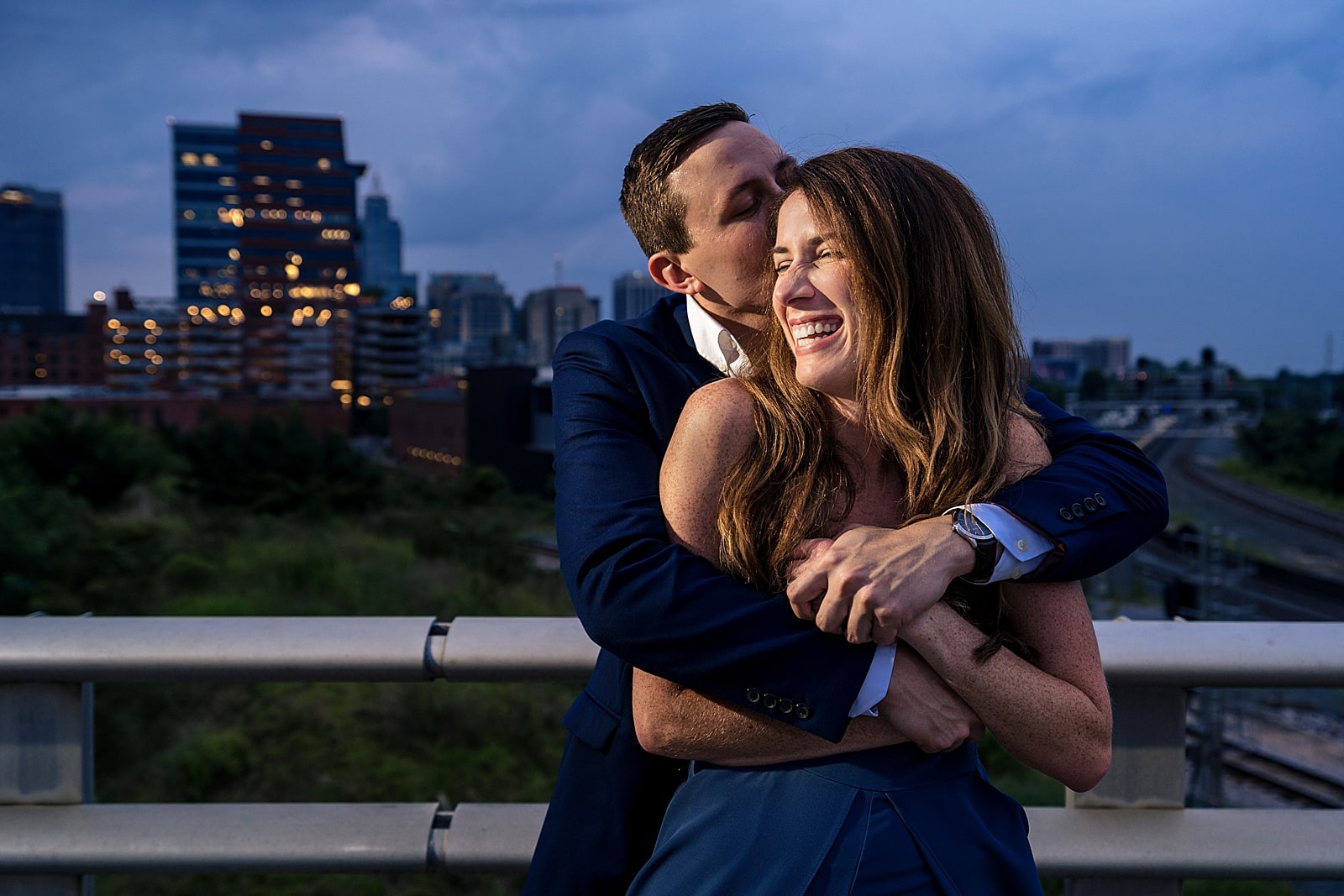 Raleigh engagement photographer says make sure you get a shot with the Raleigh skyline at your engagement session