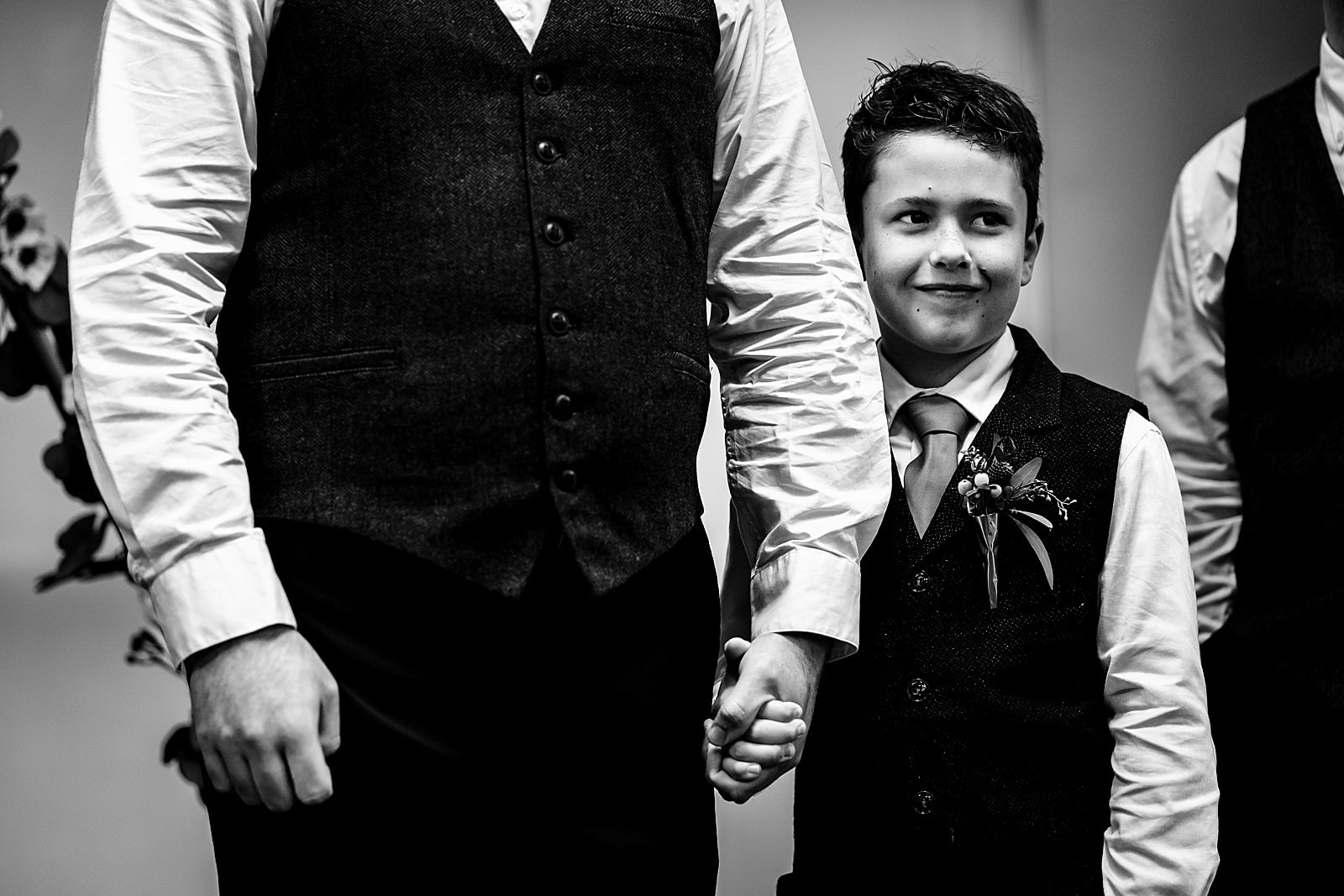 the groom's son smiles as the bride walks down the aisle