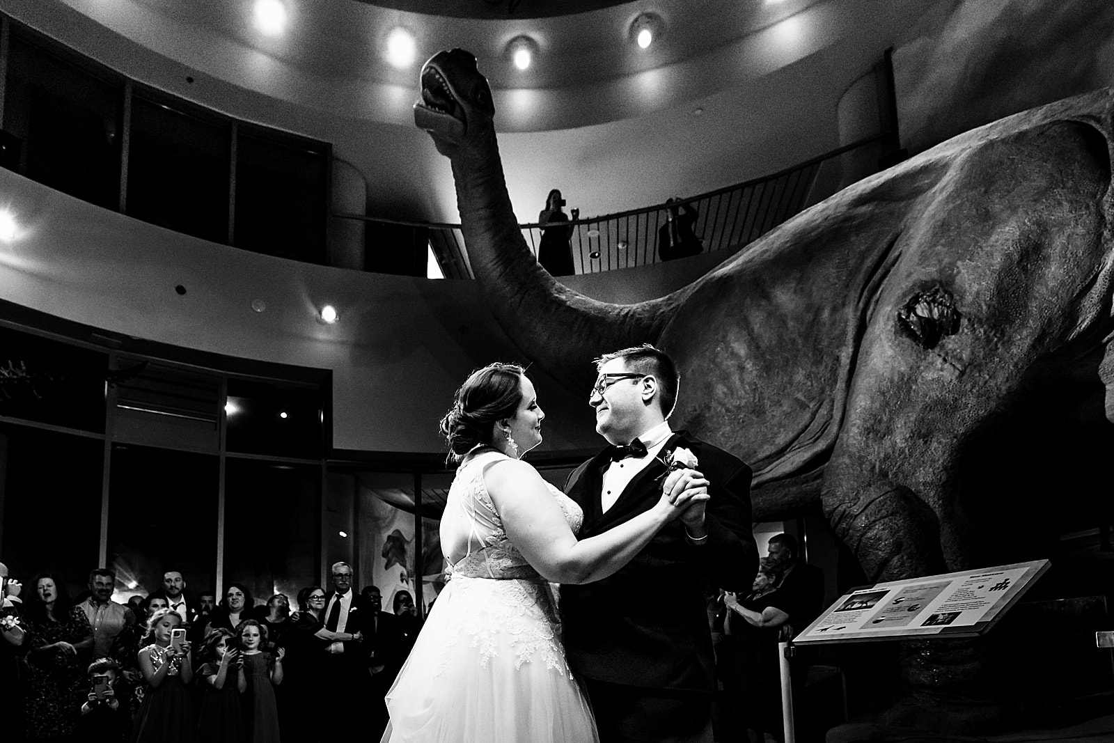 this first dance at a Science museum wedding had the couple dancing surrounded by dinosaurs