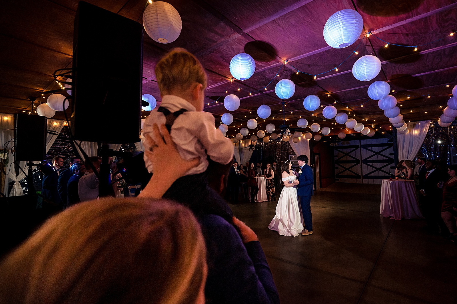 adorable little ring bearer watches the first dance at the wedding