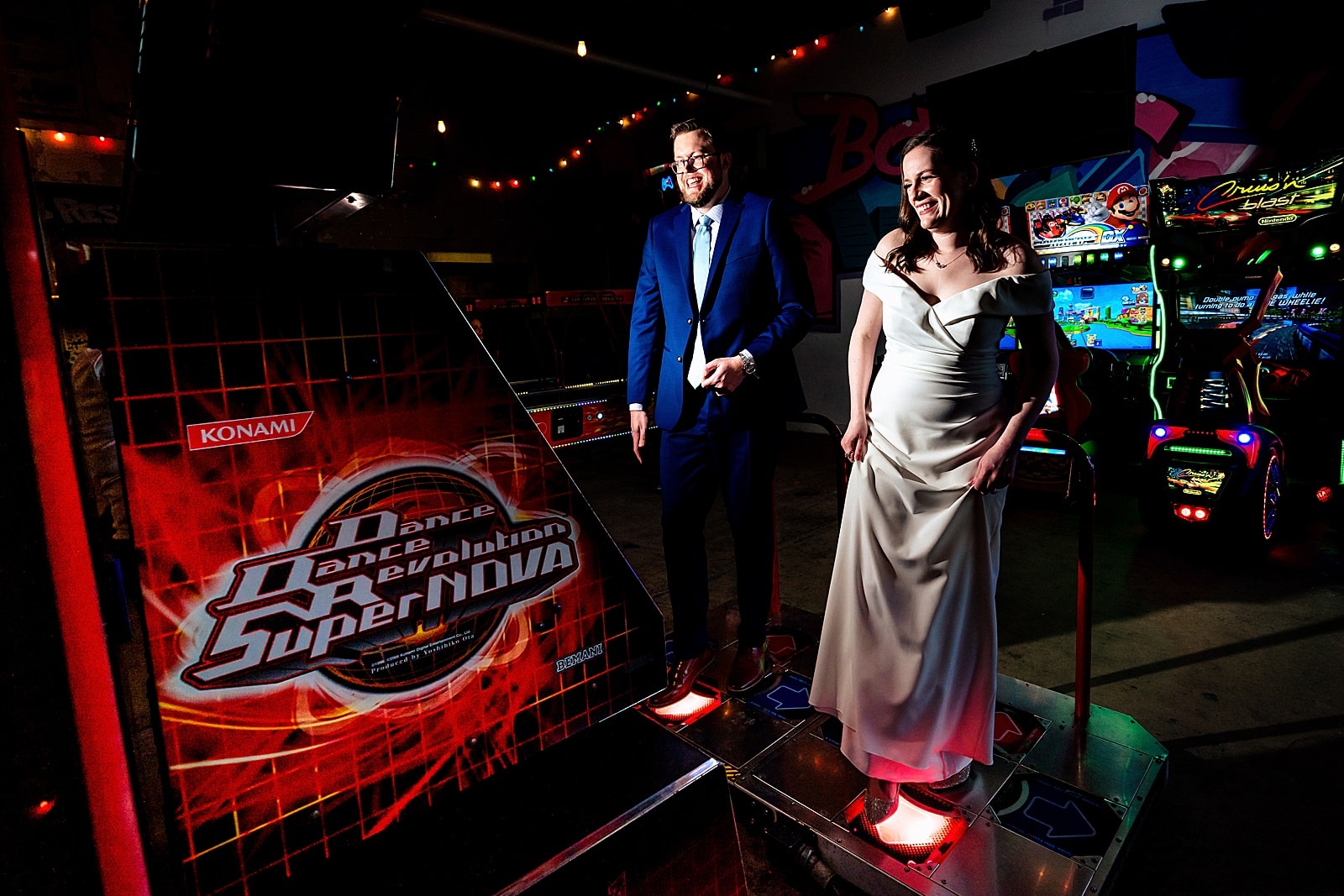 Bride and groom playing arcade games at a Boxcar Bar + Arcade wedding by Durham wedding photographers Kivus & Camera