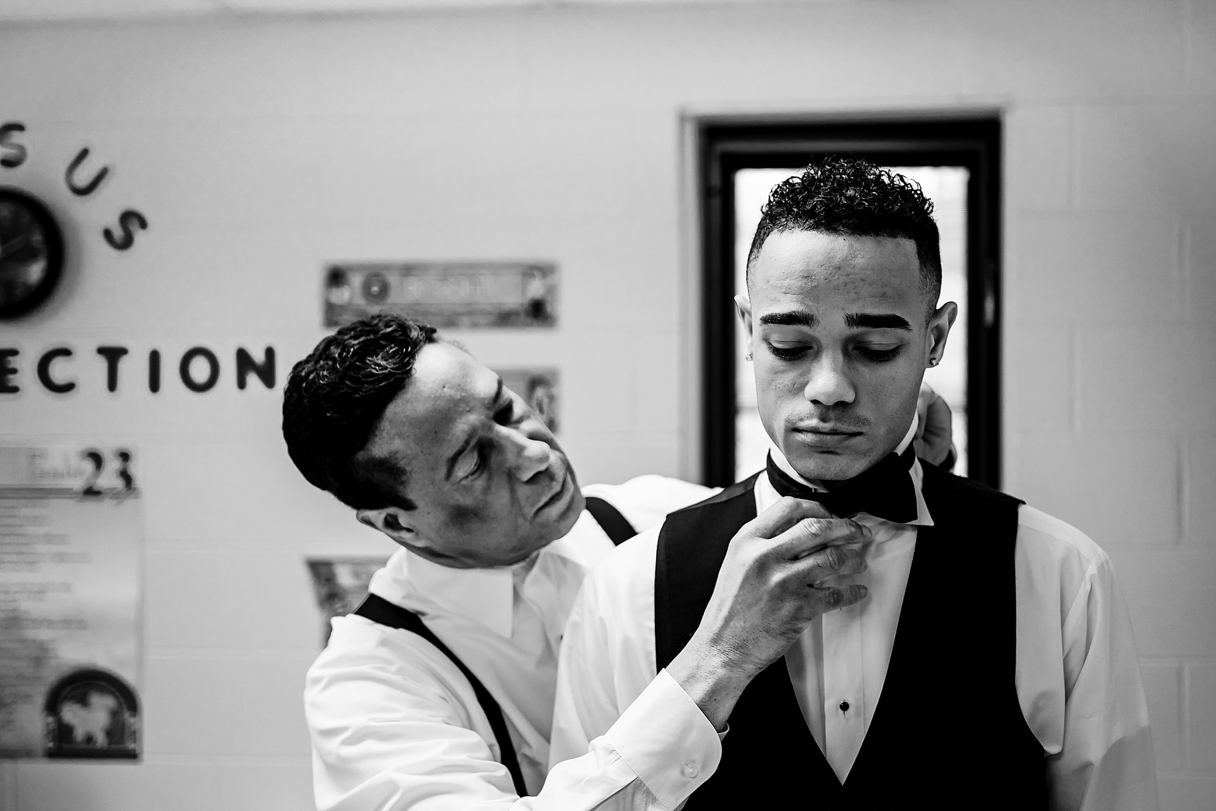 Groom's father helps him put his bowtie on at a church in Durham, NC | photos by Kivus & Camera