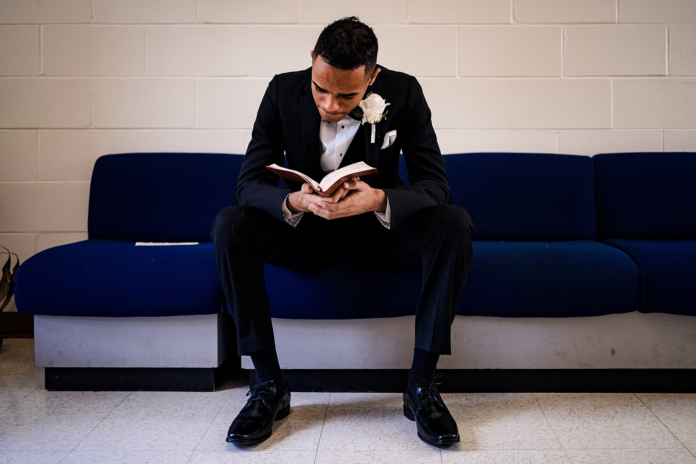 Groom sits with his bible before wedding ceremony begins | photos by Kivus & Camera