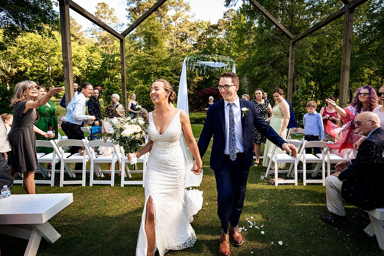 newlyweds recess down the aisle at this Carriage House summer wedding by Chapel Hill wedding Photographers Kivus & Camera