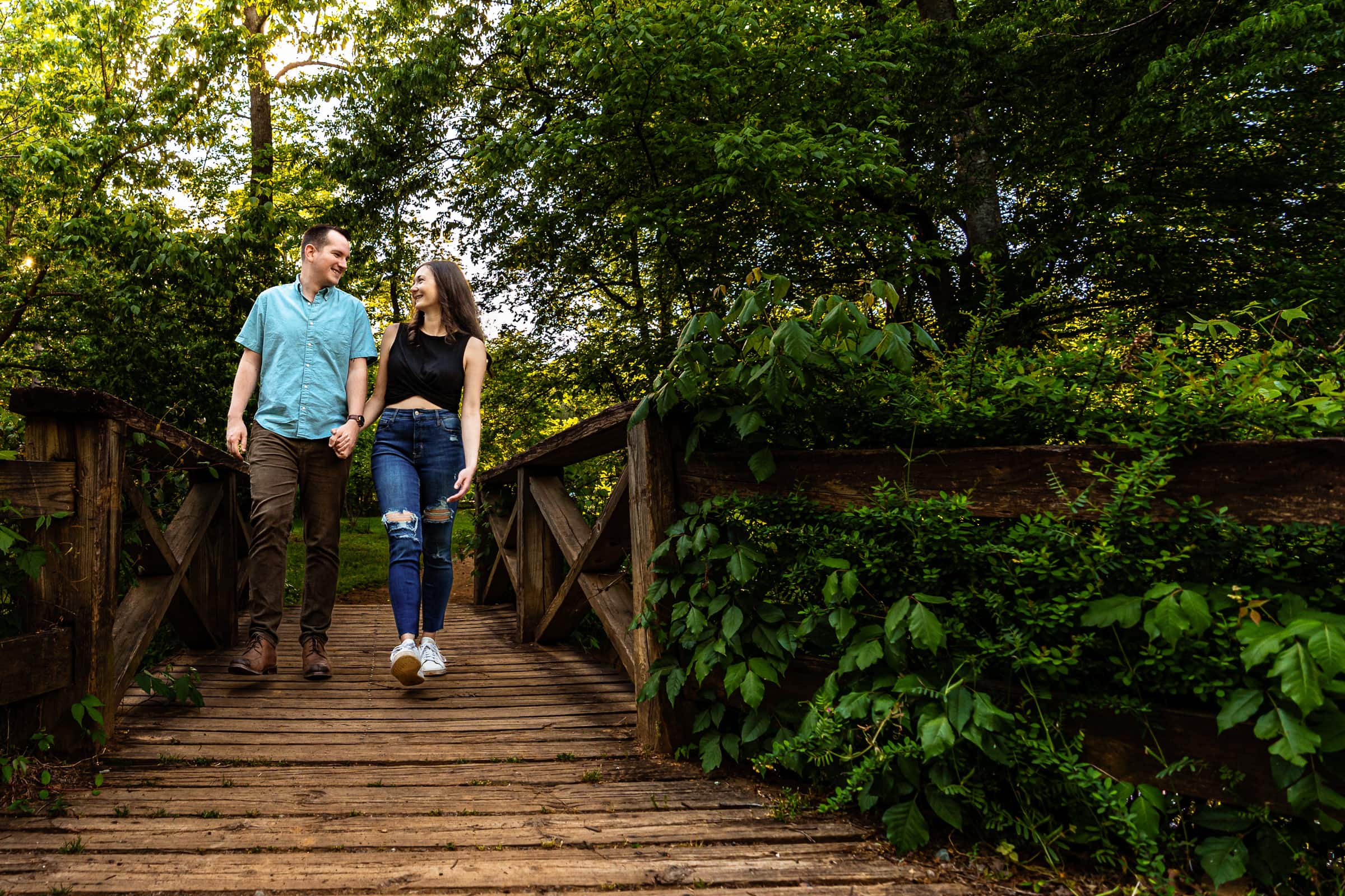 Couple walks hand in hand through West Point on the Eno | photo by Kivus & Camera