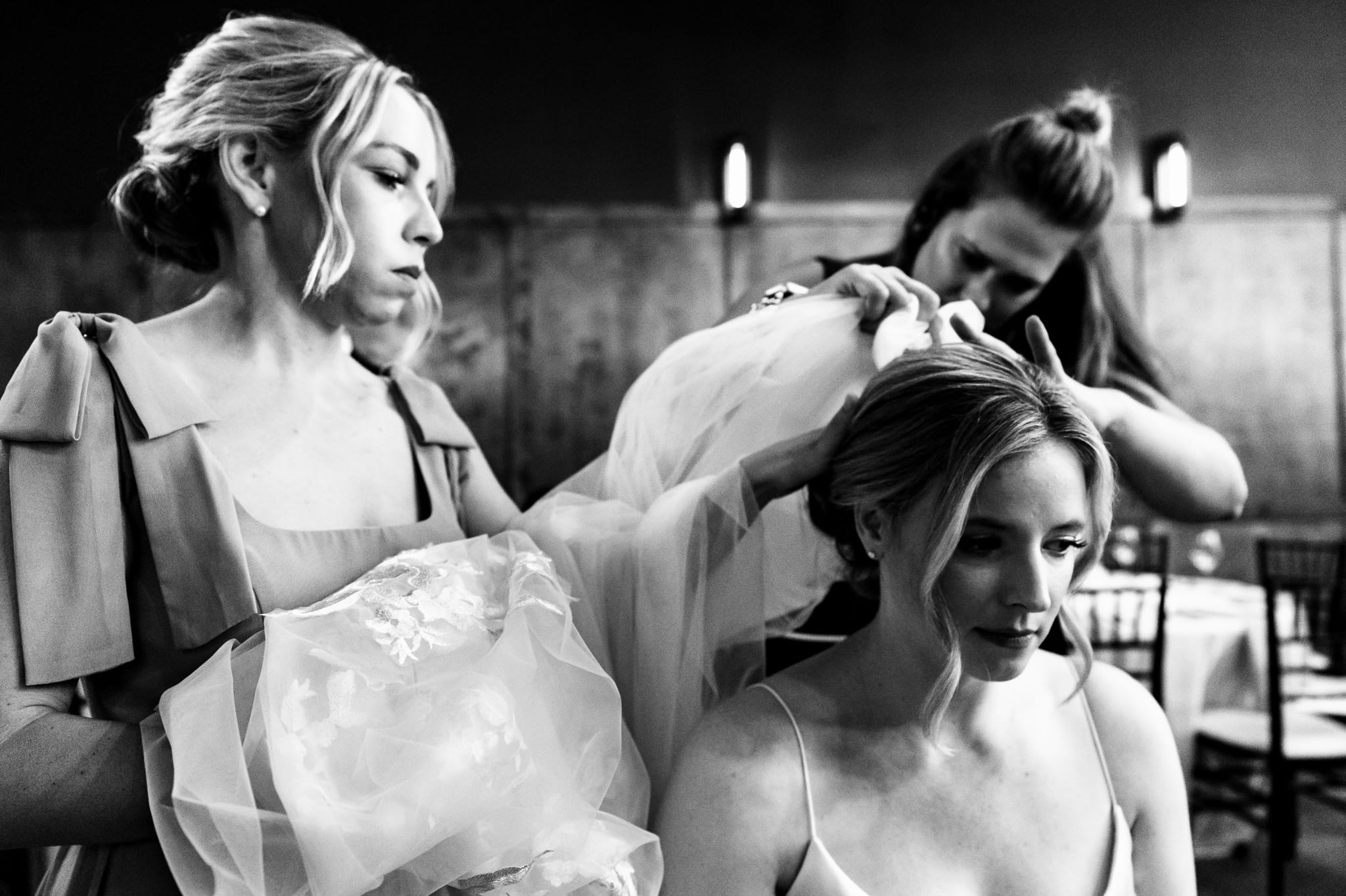 bridesmaids help the bride with her veil | photo by Kivus & Camera