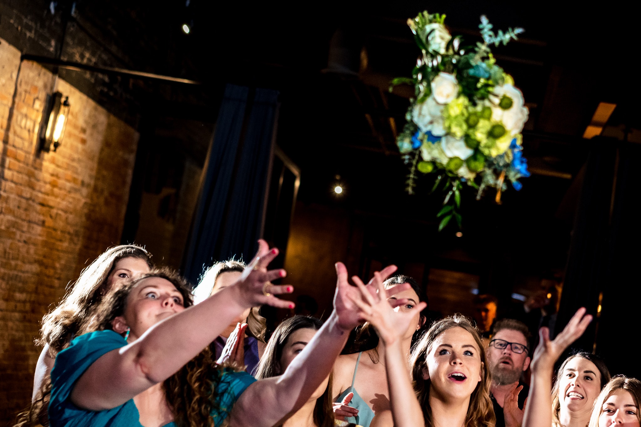 hilarious bouquet toss at The Grove at City Market | photo by Kivus & Camera