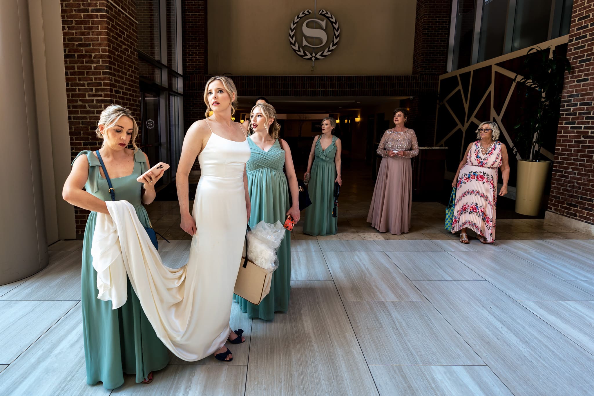 bride and her bridesmaids wait in a hotel lobby for transportation to the wedding | photo by Kivus & Camera