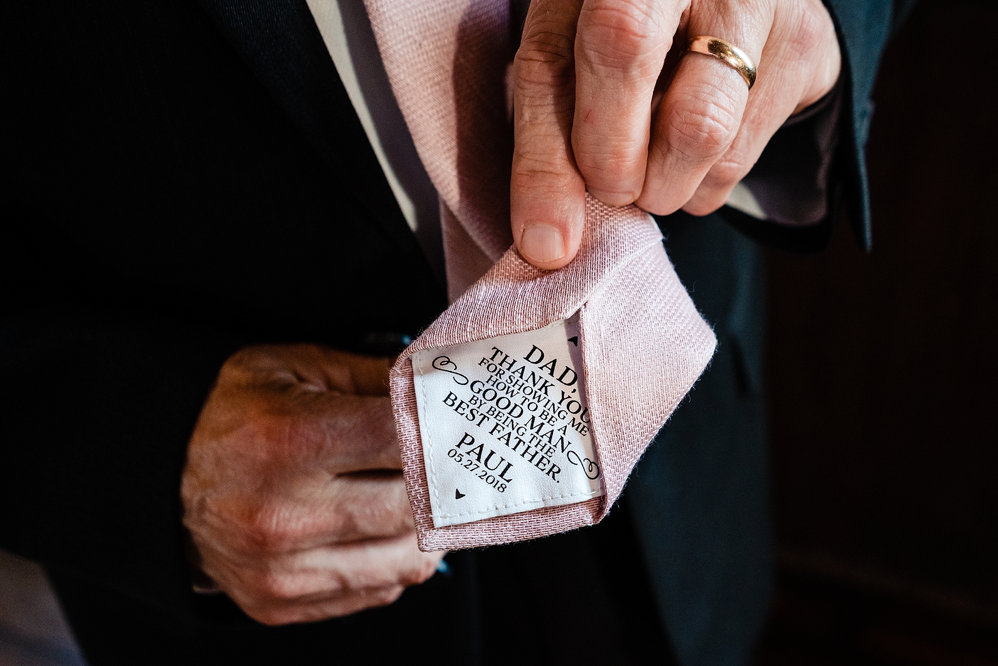 Gift for Father of the Groom is a tie with a special message embroidered in the back