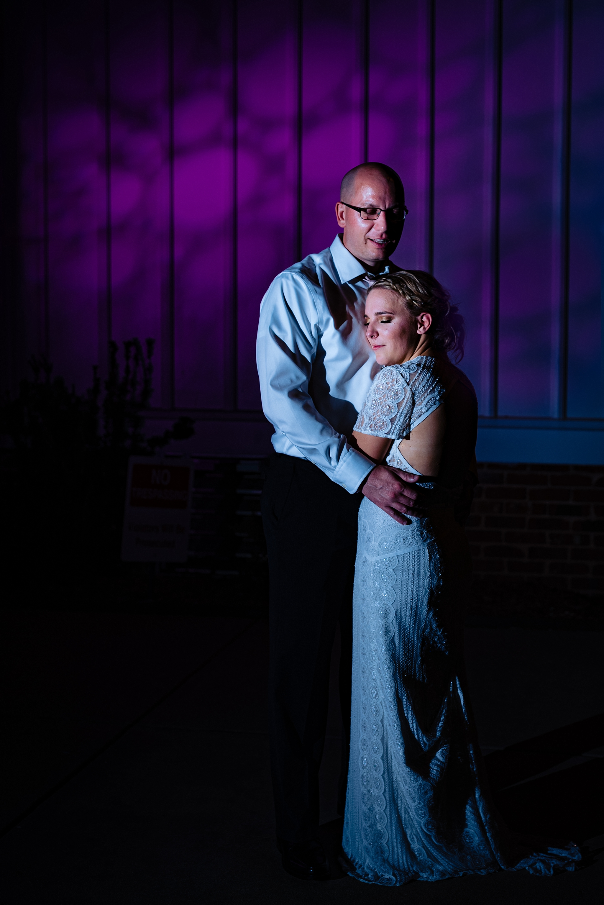 Bride and Groom pose for a dramatic night time portrait outside of their All Saints Chapel wedding