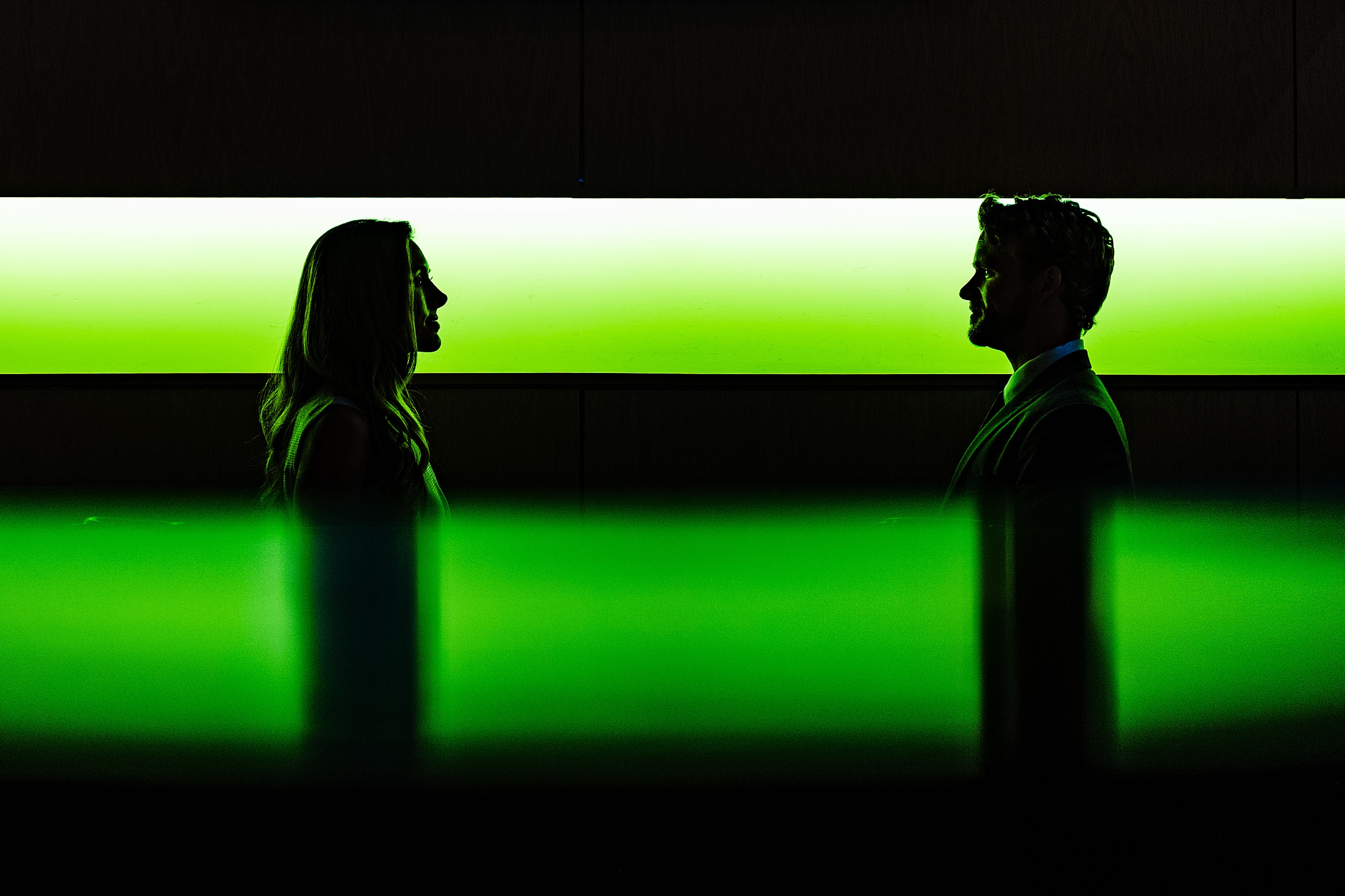 Creative and dramatic portrait of wedding couple with a green background and reflection | kivusandcamera.com