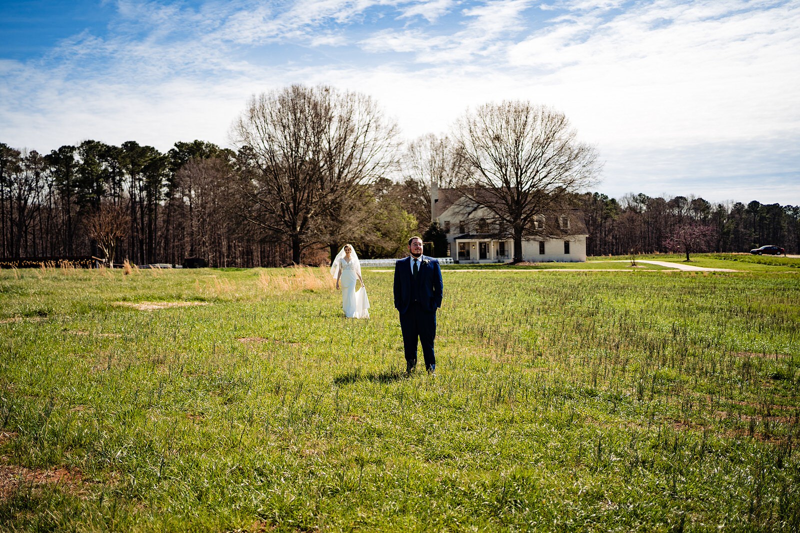 Bride comes up behind groom for their first look at The Meadows Raleigh