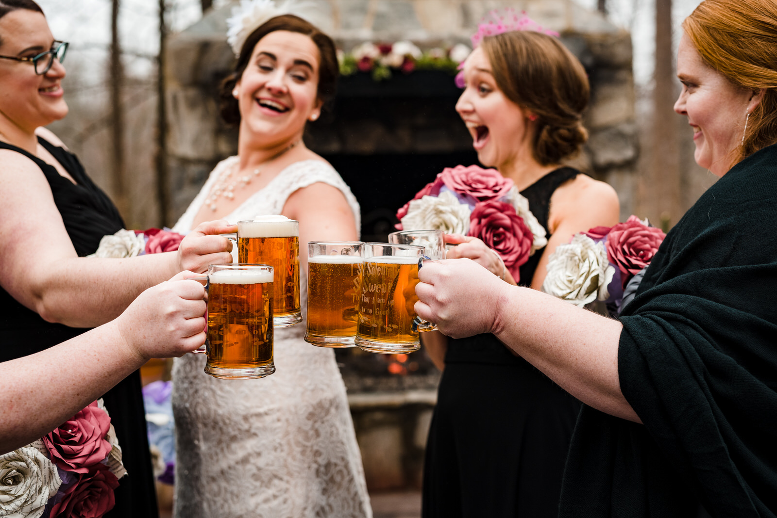 bride and bridesmaid toast with beer steins