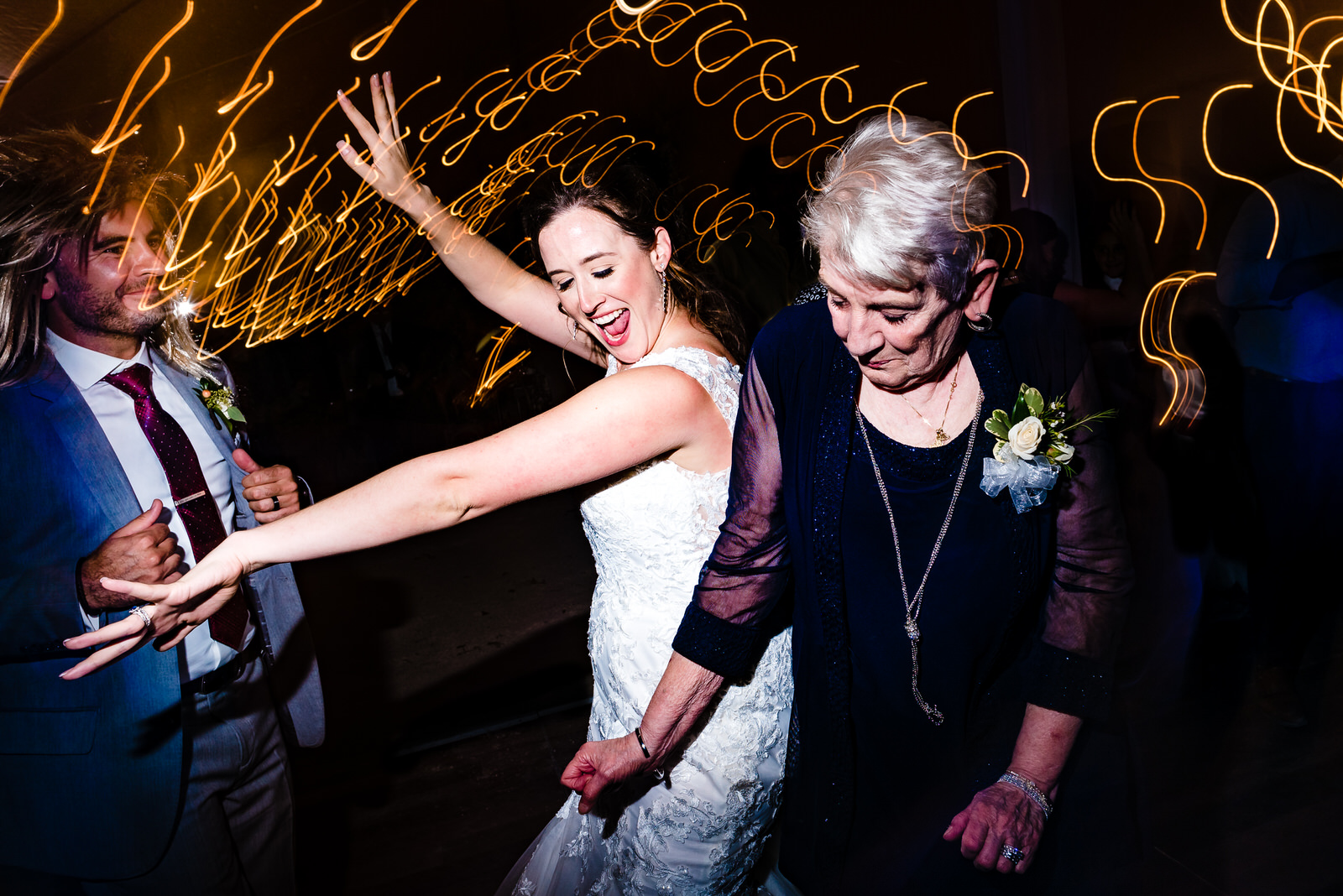 Bride dances with the groom's grandmother at her wedding reception by Raleigh wedding photographers