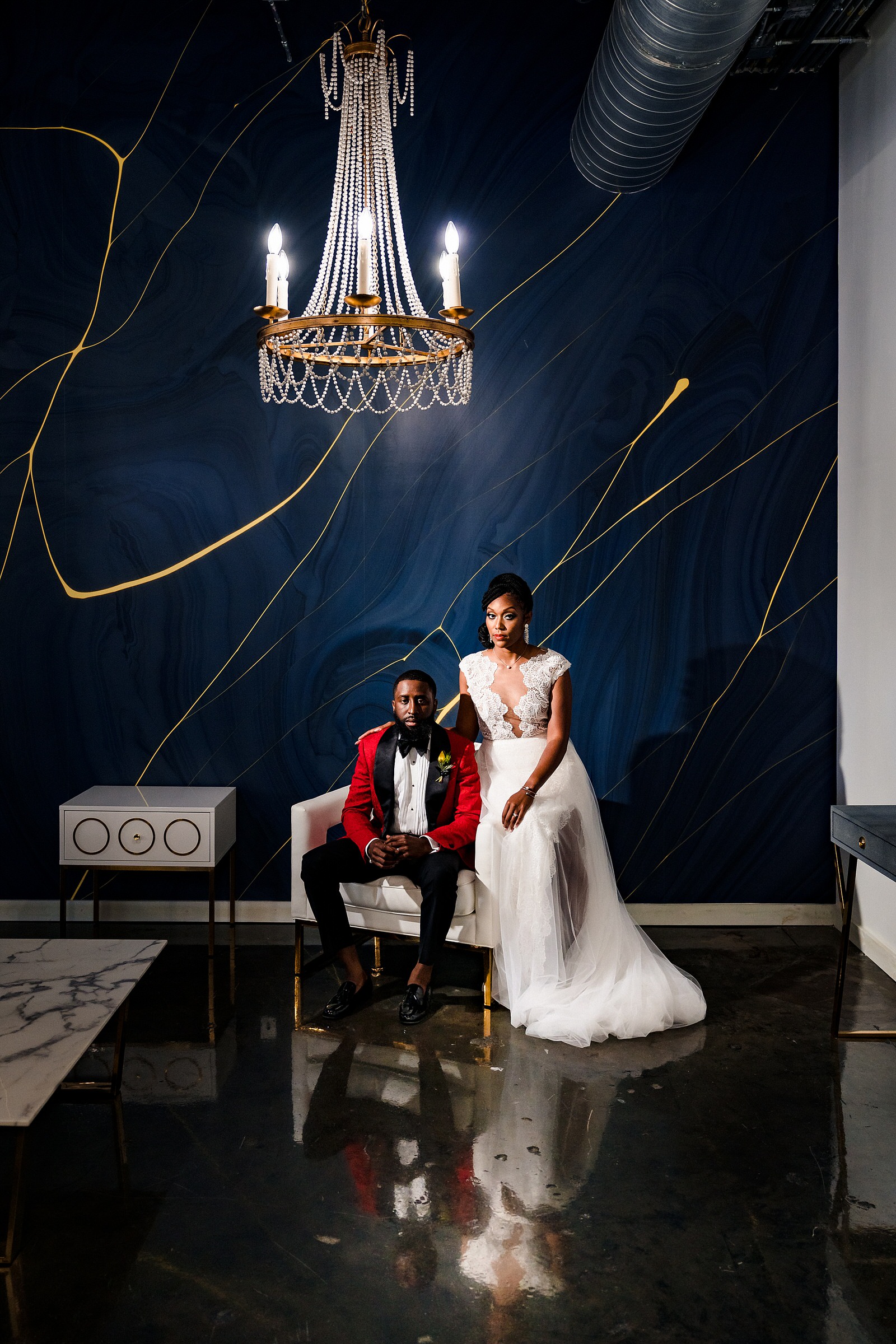 Groom in a Robert Jamison Collection custom suit and bride in a Gavin Christianson Bridal gown pose in the bridal suite at the Cotton Room