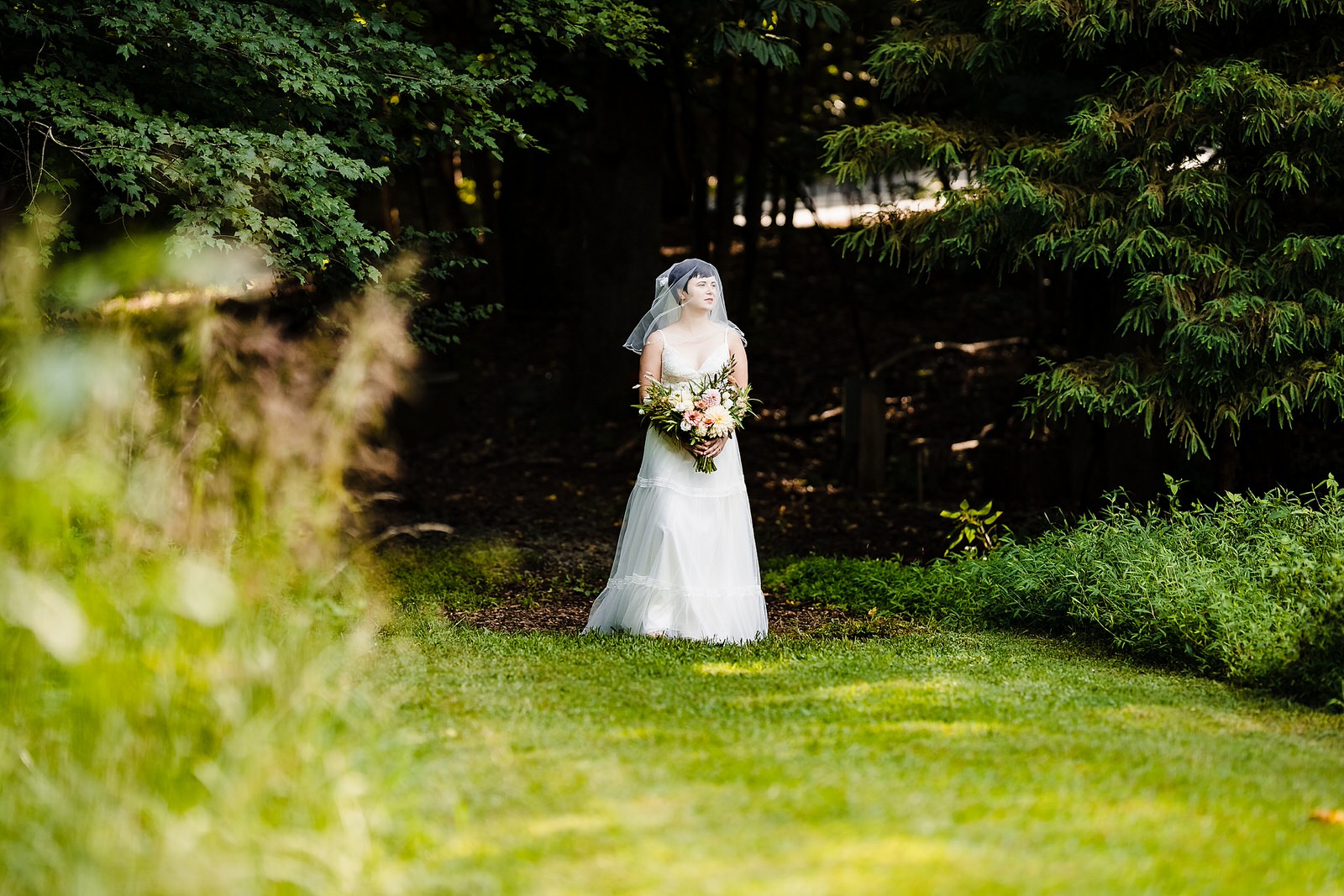 Bride with a veil over her face walks toward her Chapel Hill elopement
