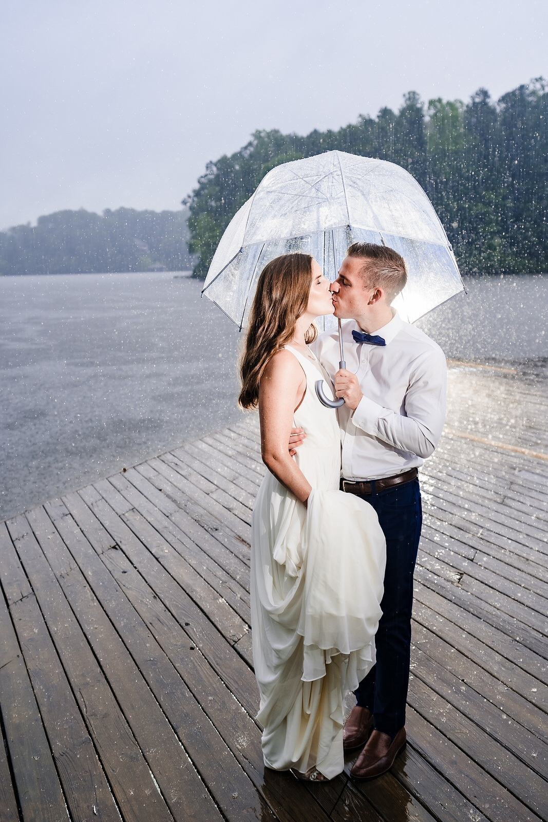 bride and groom embrace in the rain at an intimate, backyard wedding