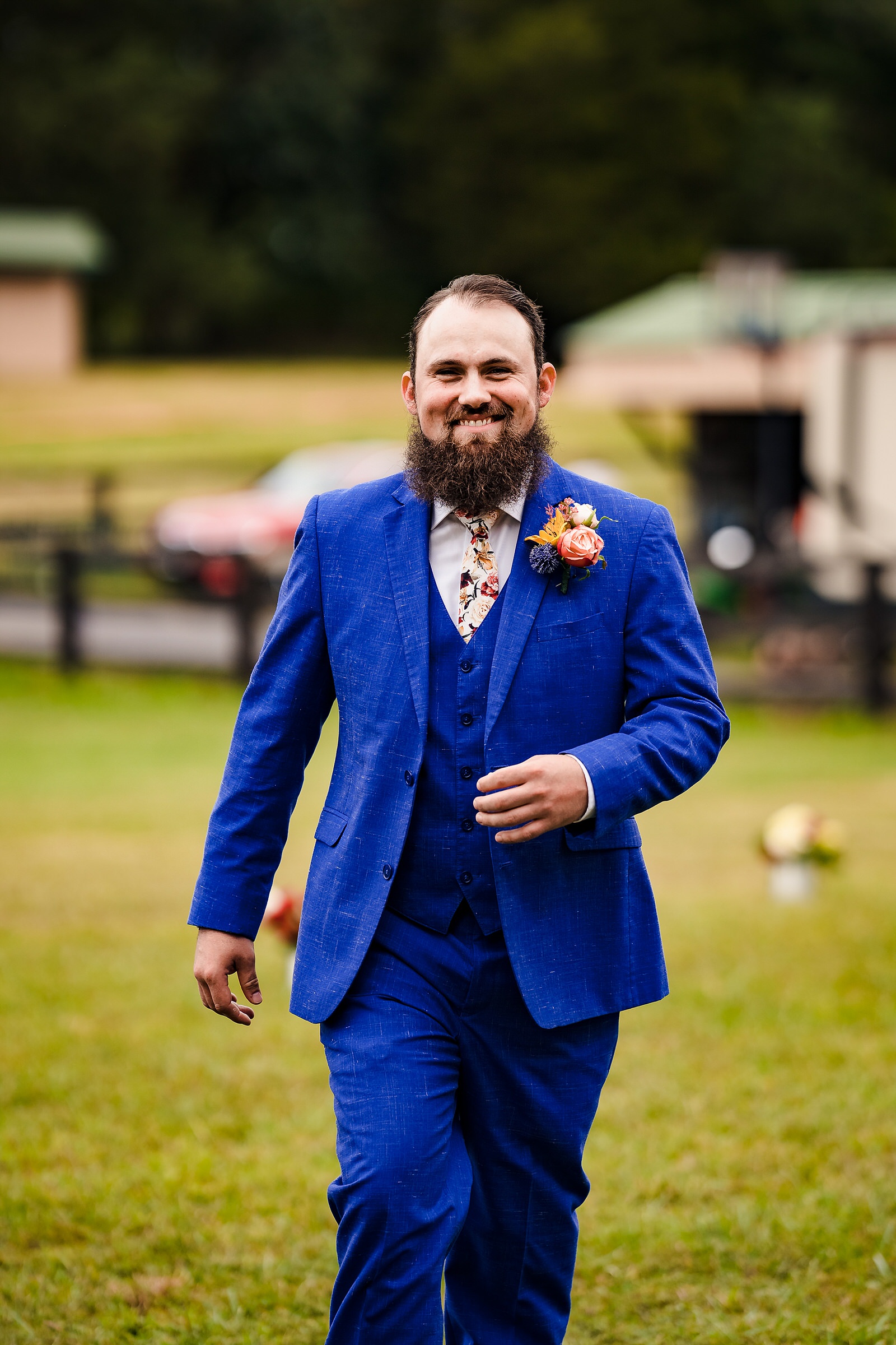 Groom smiles as he walks into the ceremony