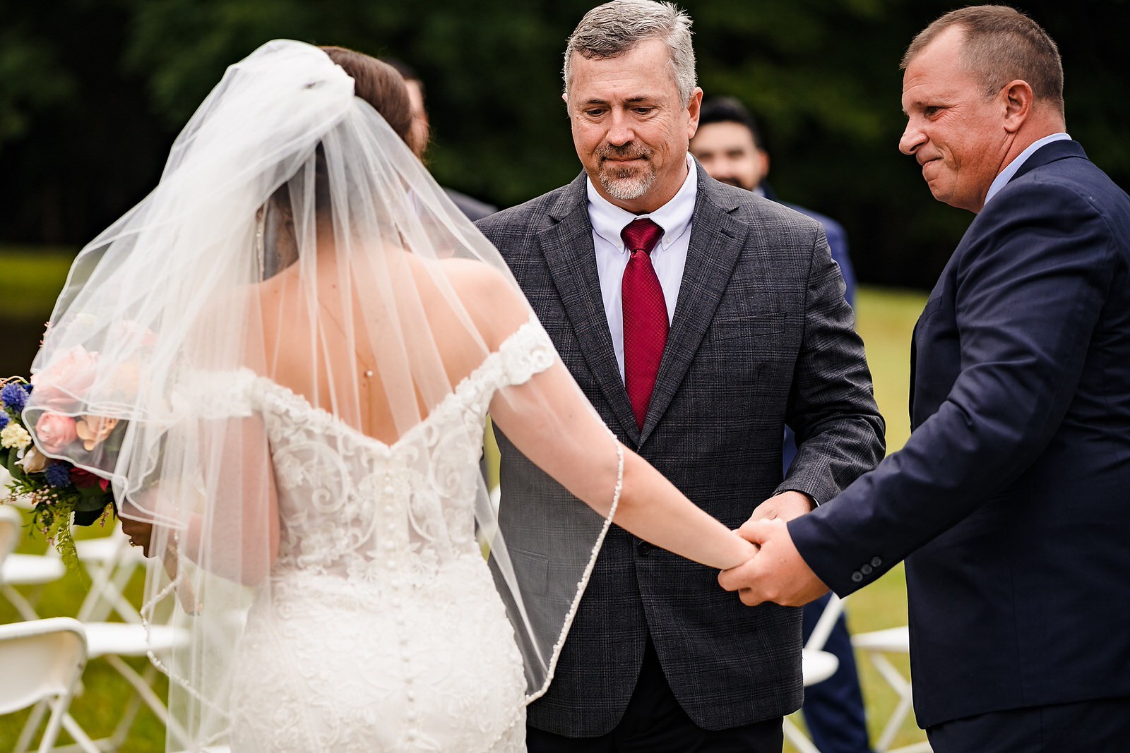 Father of the bride hands her off to her stepfather, so her stepfather can walk her down the second half of the aisle