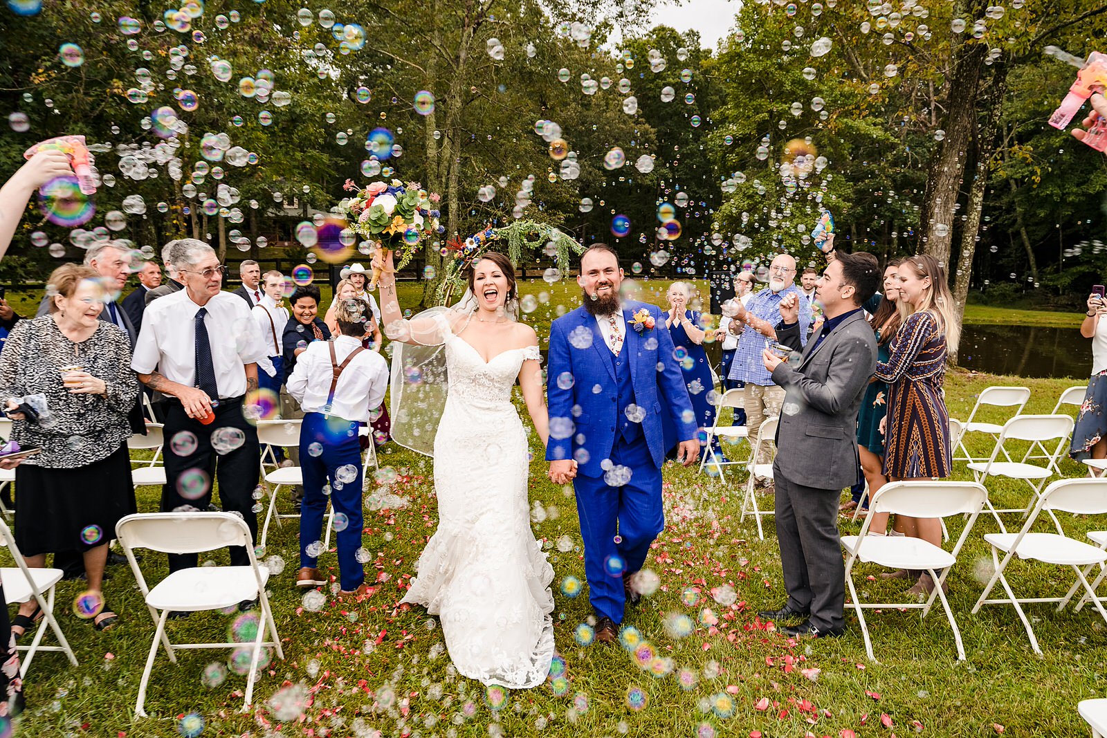 Bride and groom recess down the aisle to bubbles after their wedding ceremony