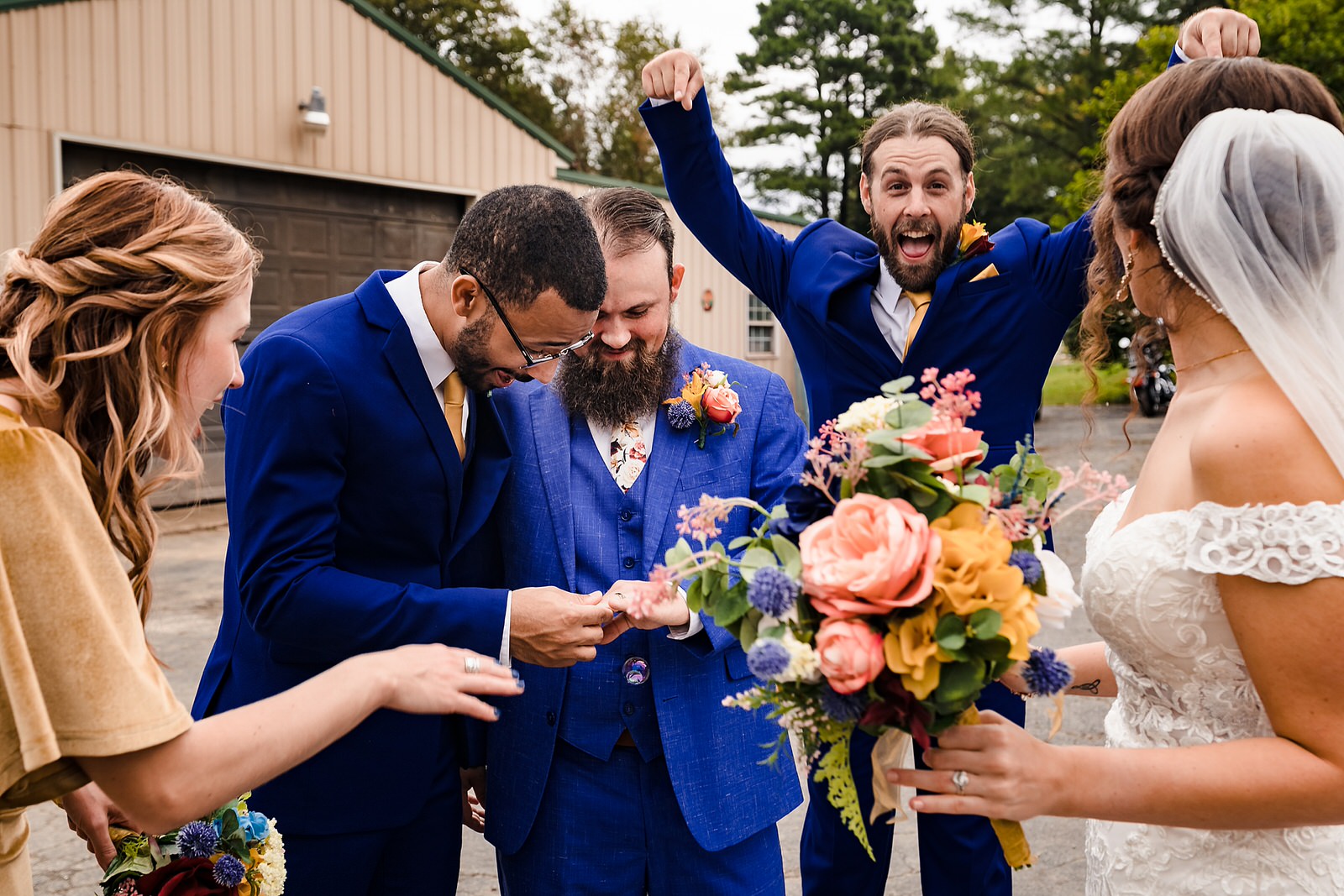 Groom shows off his new wedding ring to groomsmen