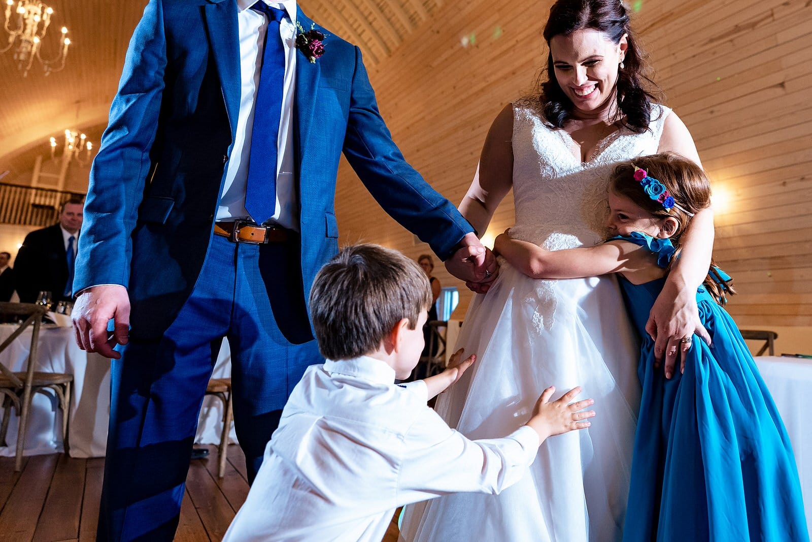 Bride attacked with hugs from niece and nephew as bride and groom enter reception