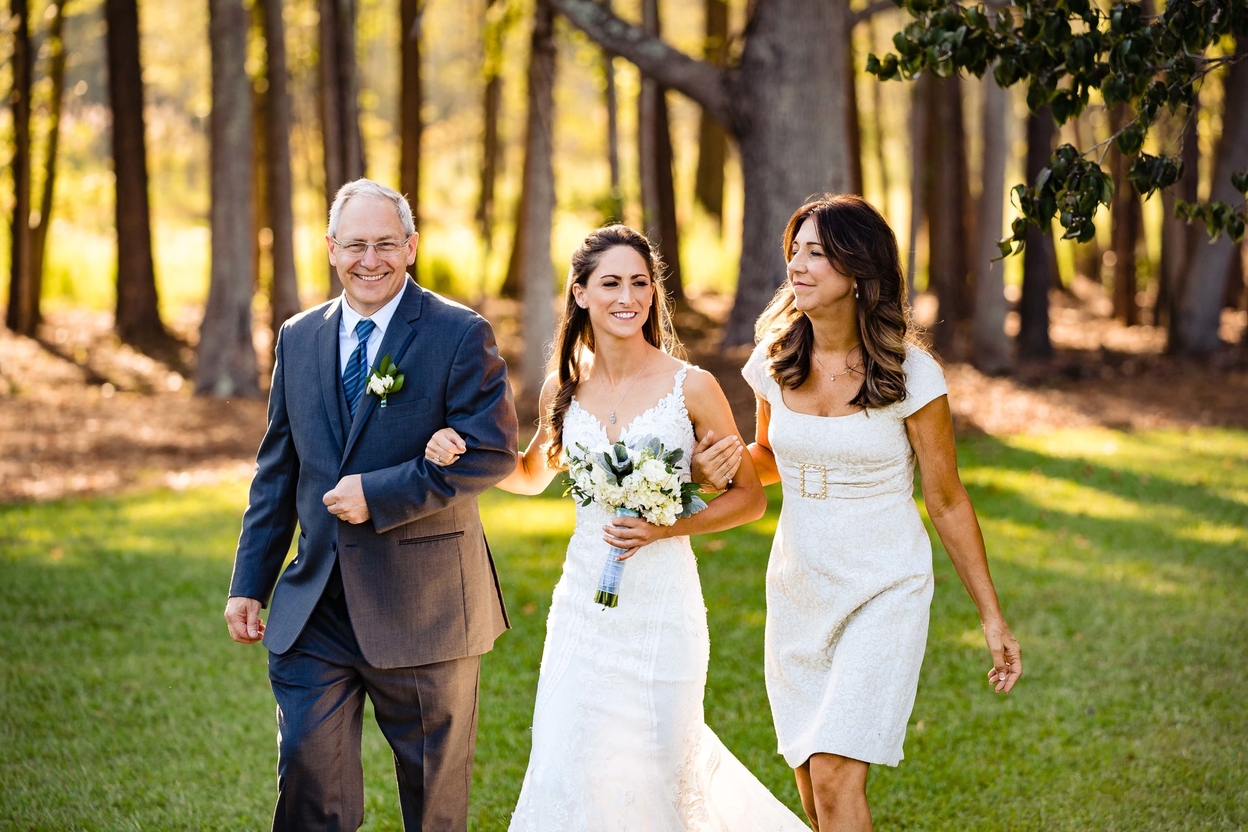 If you have two photographers at your wedding, you can get both angles of the first look and the walk down the aisle - here, one photographer has captured the bride walking in with her parents