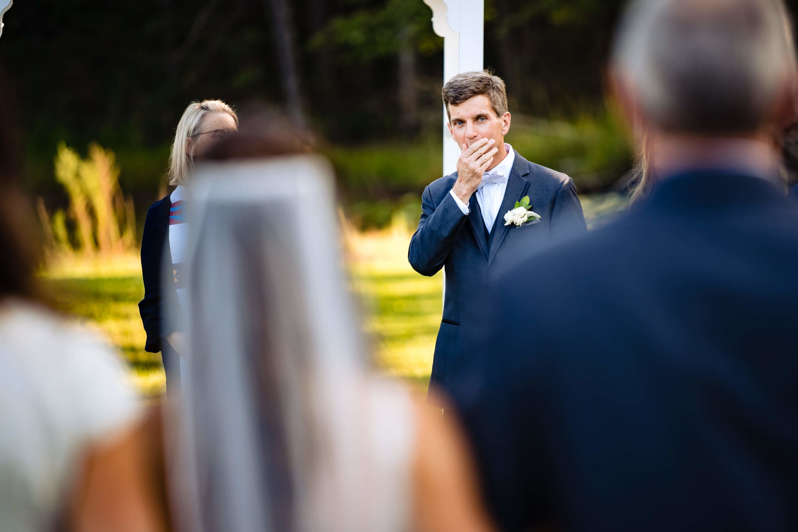 If you have two photographers at your wedding, you can get both angles of the first look and the walk down the aisle - here, one photographer has captured the groom's reaction as the bride walks down the aisle. The other photographer photographed the bride walking in