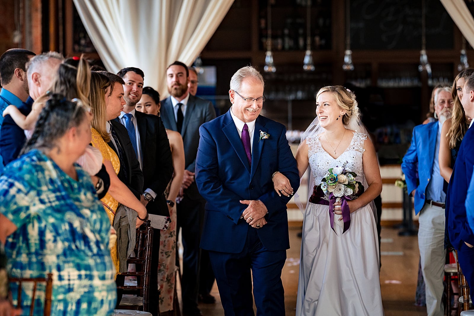 Bride and her father make their way down the aisle at The Cotton Room