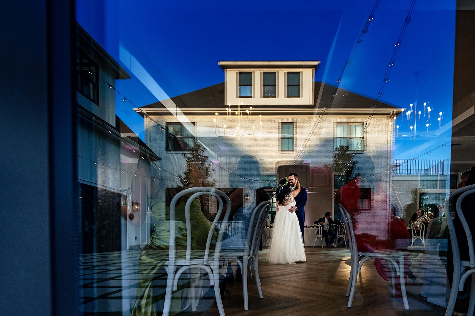 Bride & groom's first dance in The Bradford wedding ballroom. The main house is reflected in the window