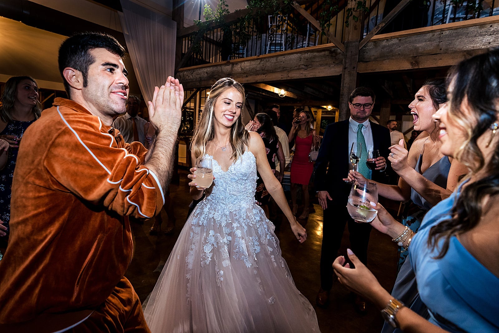 this groom changed into an orange velour jumpsuit for his reception