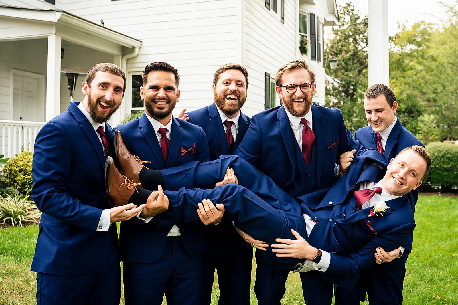 Groomsmen style inspiration - blue tuxedos with red ties
